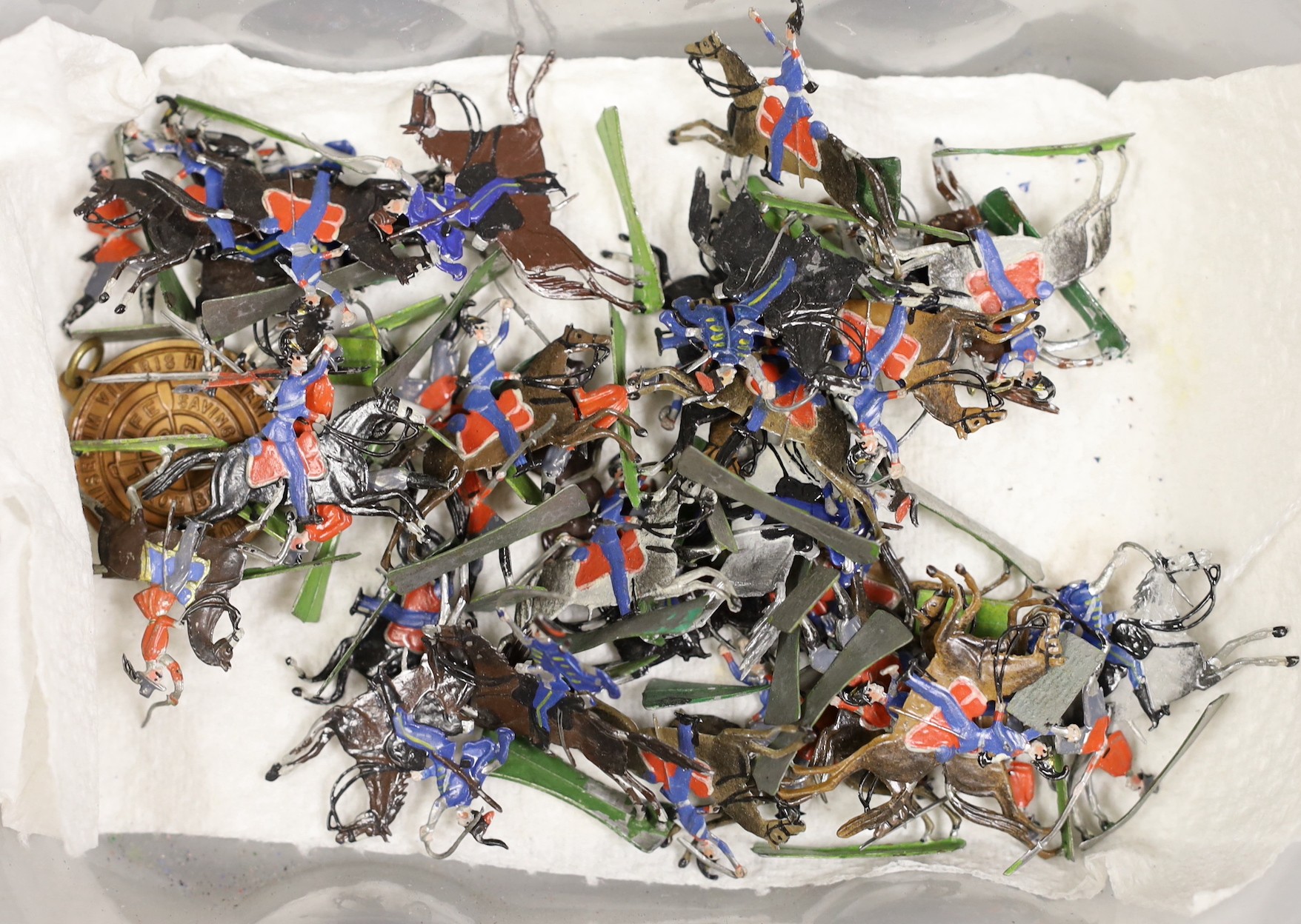 A collection of miniature flat toy soldiers